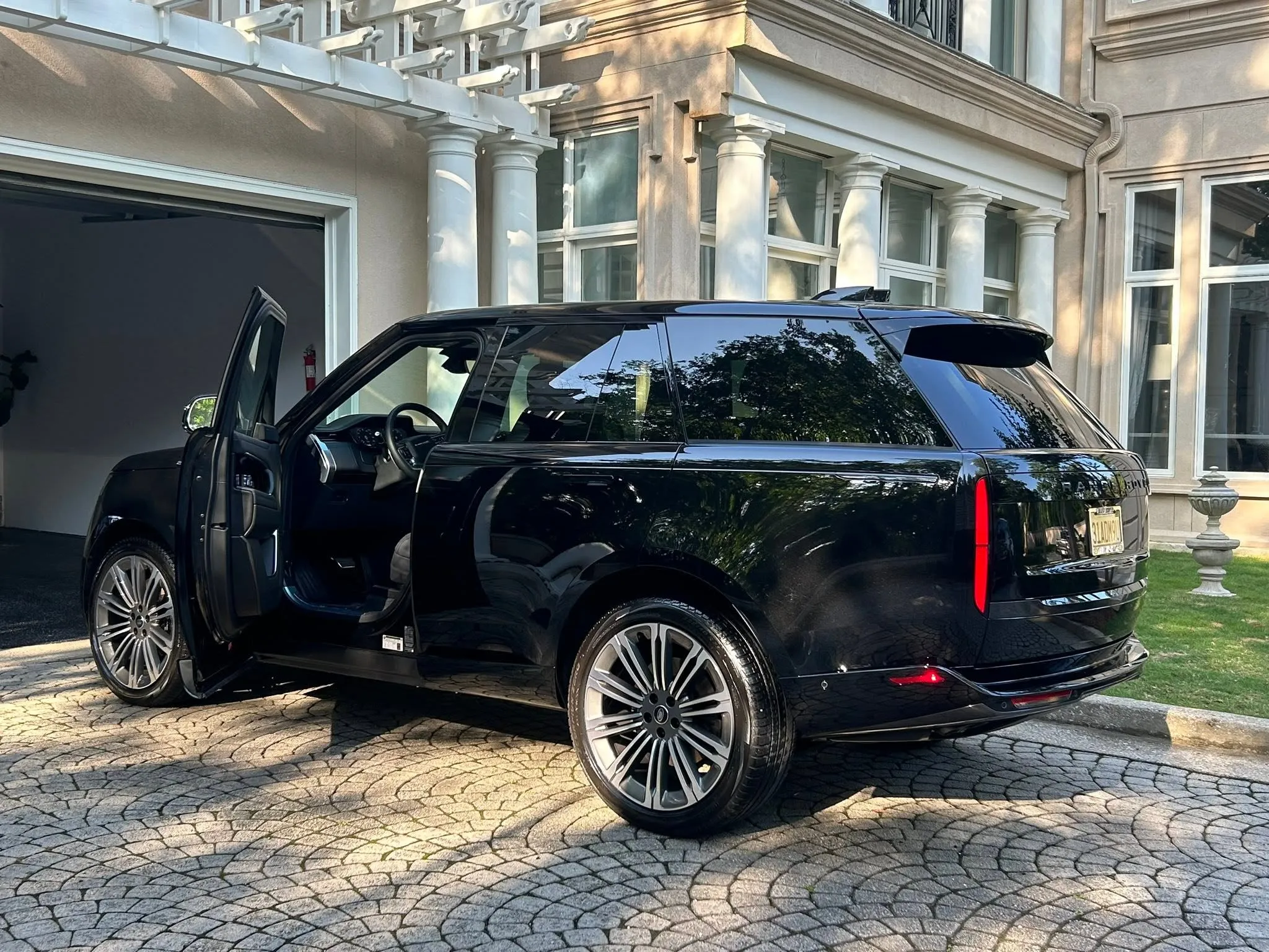 Detailed black SUV in a private driveway after mobile detailing in Birmingham, Alabama